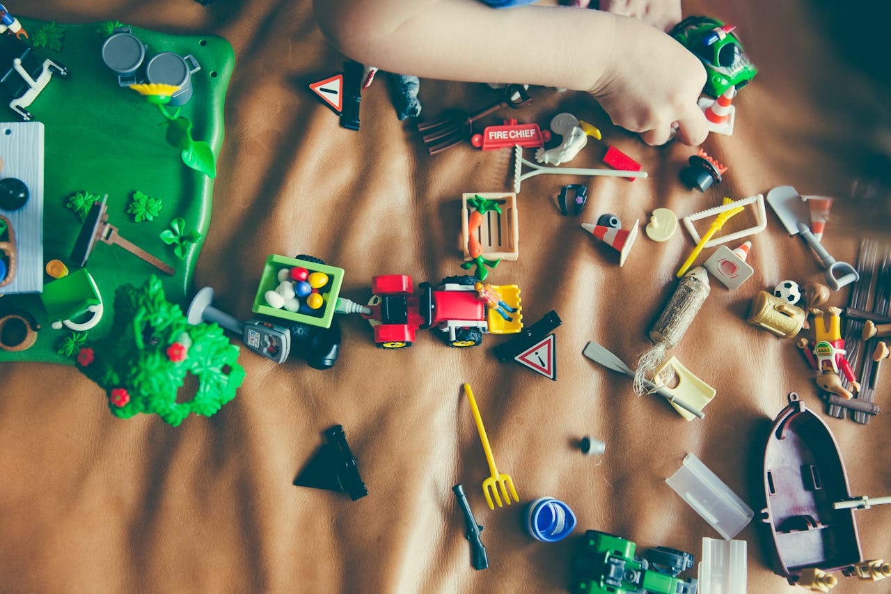 who-we-are Children's hands playing with colorful toys on a mat, sparking creativity and fun.