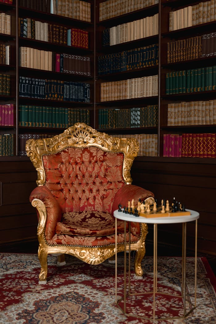 services-bg Luxurious library corner featuring an ornate chair and chessboard for a classic ambiance.